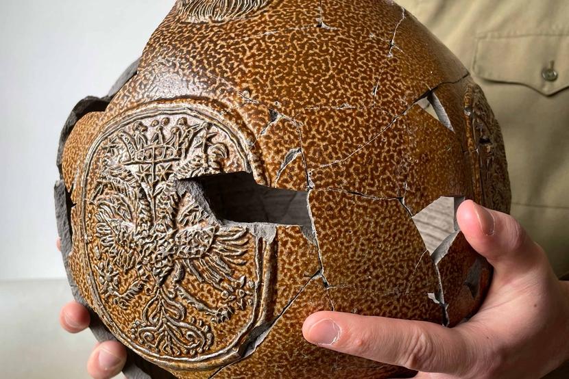 Hands holding a large reconstructed Bartmann jug