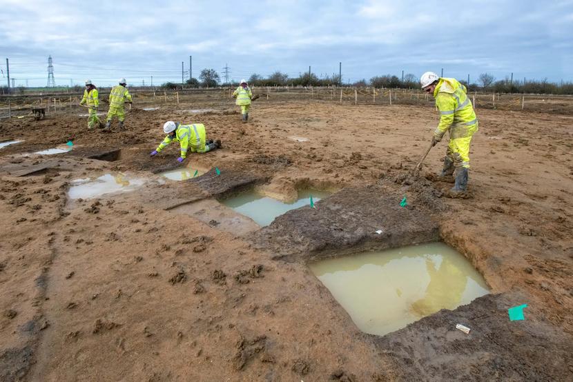 Archaeologists excavate the remains of an iron age roundhouse
