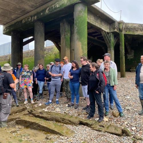TDP Archaeologist shows walk attendees a slipway at the old Royal Dock at Deptford