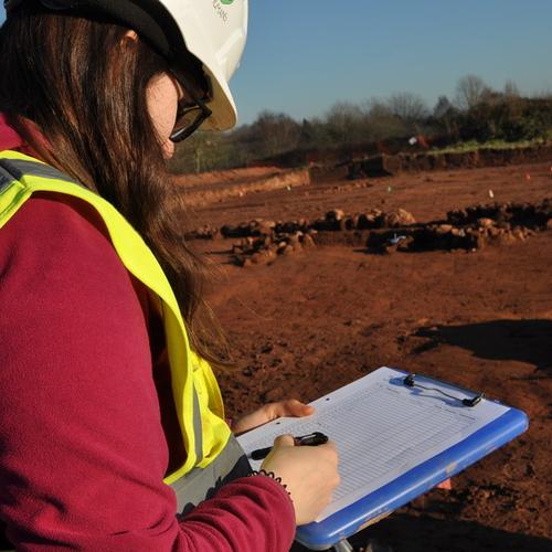 Archaeologist filling out a photo register