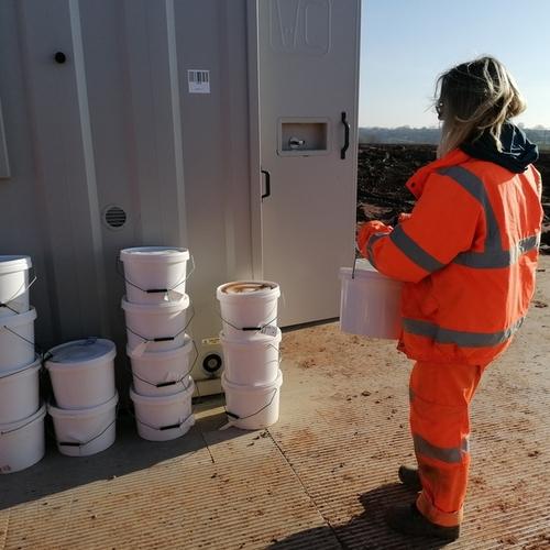 archaeologist carrying a sample bucket