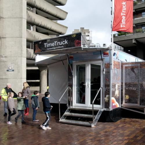 School children exploring the MOLA archaeology Time Truck (c)MOLA