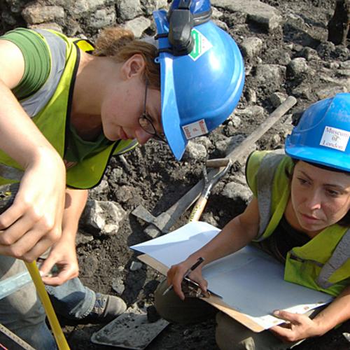 Field archaeologists from MOLA recording a section