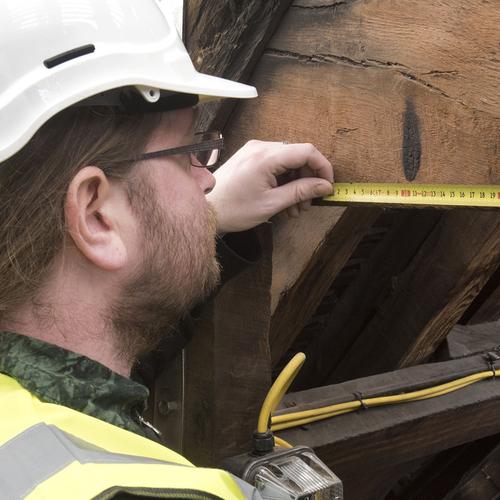 Buildings Archaeologist James Wright, inspects apotropaic scorch marks at Tower of London (c) MOLA