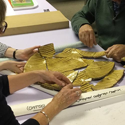 Two people learning how to study archaeological material